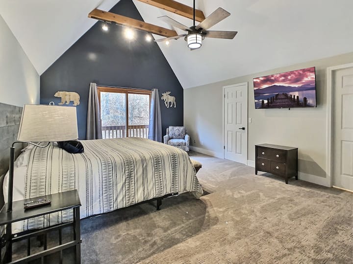 Master bedroom with king bed and balcony. 