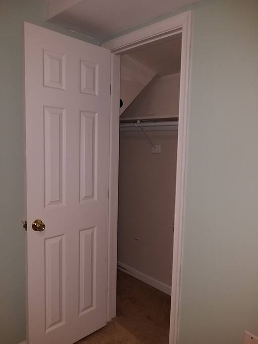 Extra large closet with deep crawl space for storage of bags.