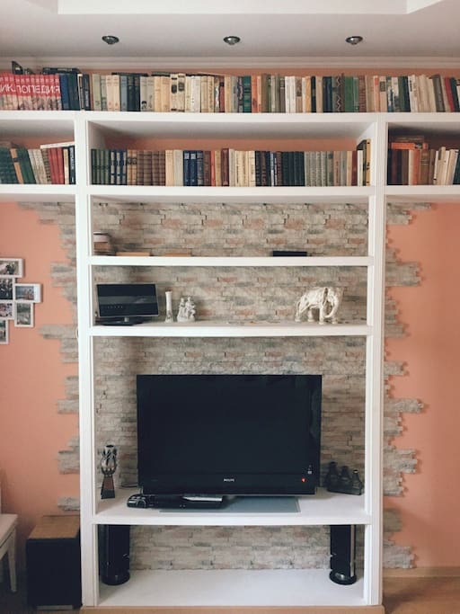 Bedroom-1 (studio couch, single bed, piano, bookshelves, TV, large wardrobe)