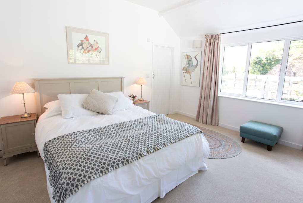 This downstairs super-kingsize bed can be split into two singles. the room has two large windows and an en-suite bathroom.