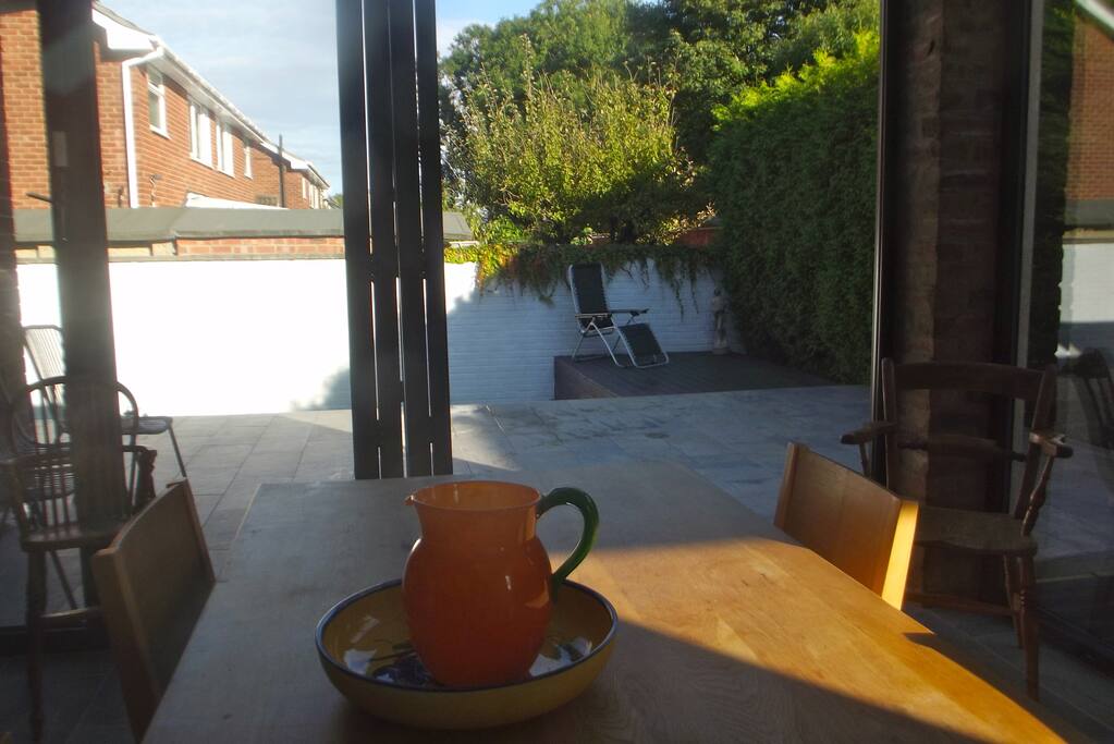 Bi-fold doors which lead out onto a sunny patio. Take the table outside and eat in the sunshine