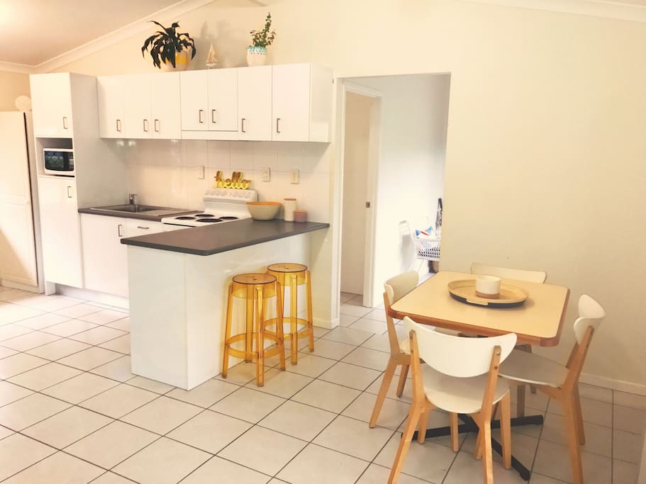 The dining area looking towards the fully equipped, light filled kitchen.