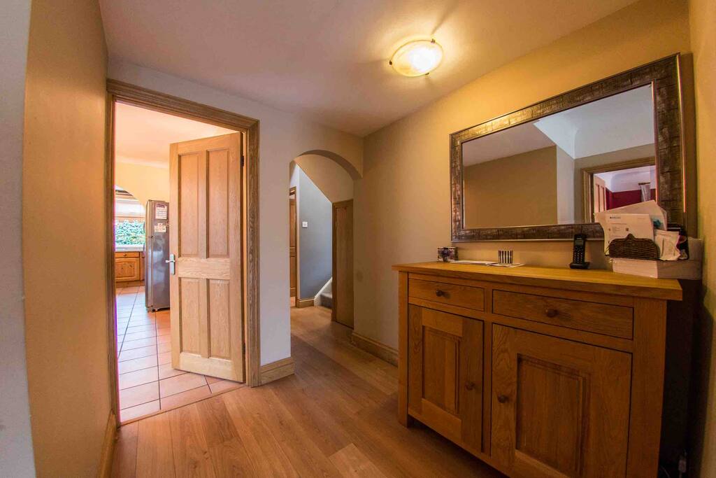 Inner Hall leading to Bedroom 2 (downstairs) and adjoining toilet through archway, and stairs.