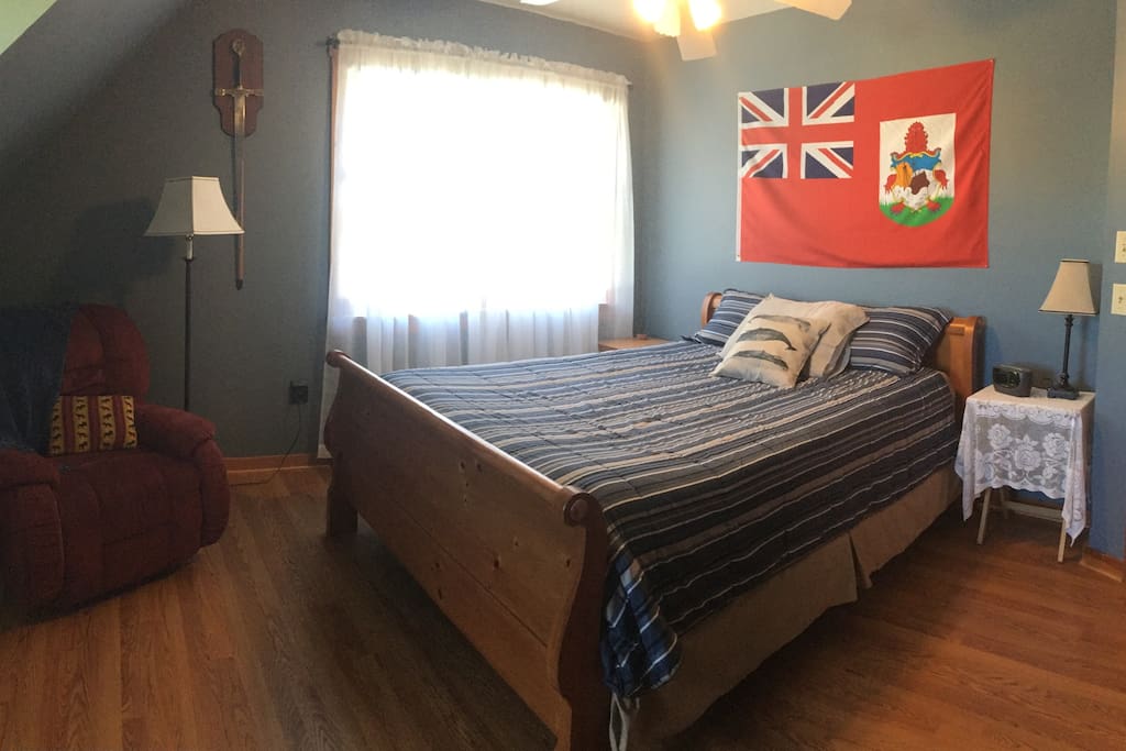 Queen sleigh bed, nightstands, recliner.