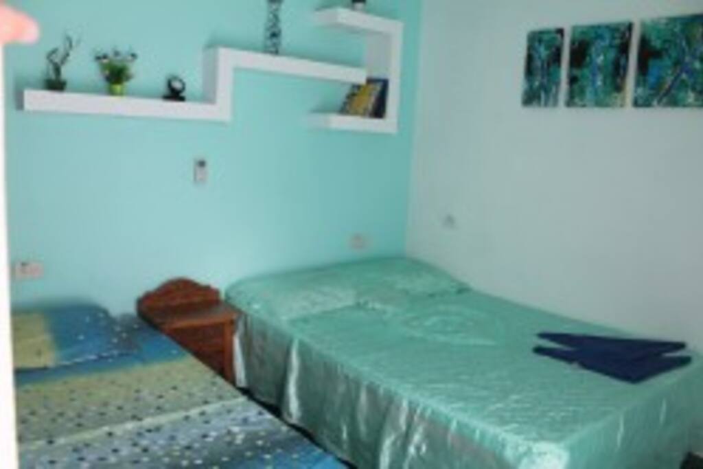 Guestroom 1 has 1 Queen medium bed & 1 Single bed. comfortable, clean with AC and Fan.