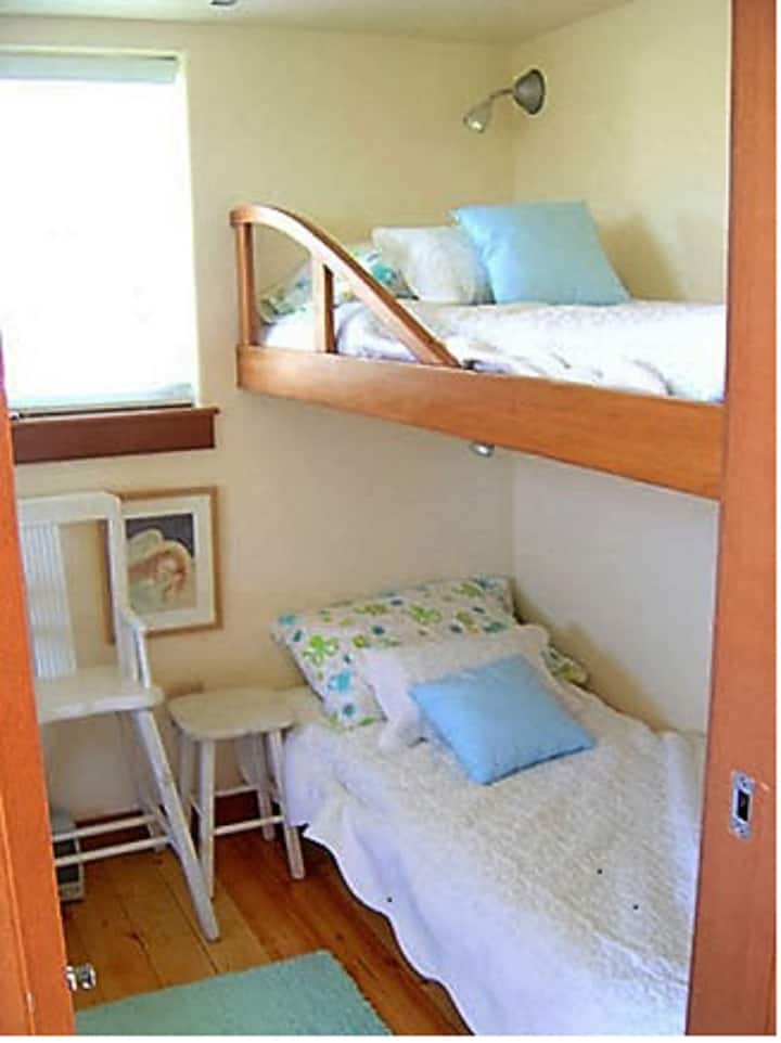 The bedroom has two comfortable bed bunks.