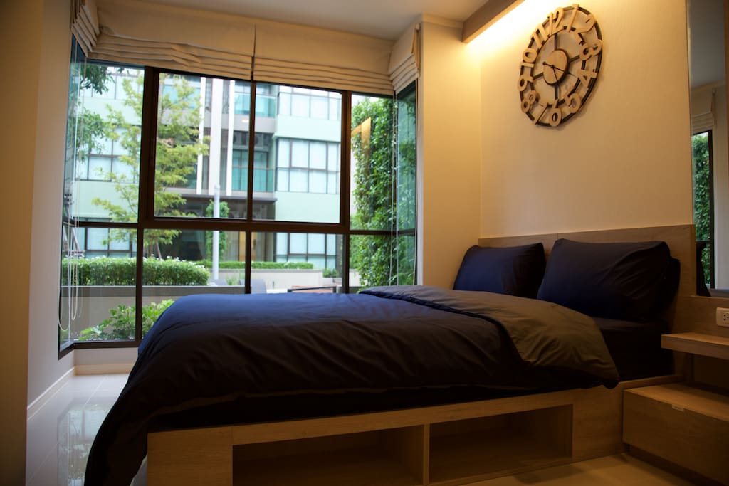 Beautiful bedroom with queen sized bed. View of swimming pool from the bedroom.