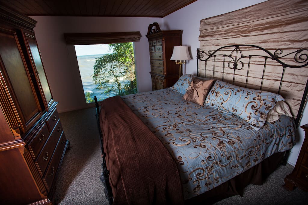 View of the beach through the master bedroom picture window,