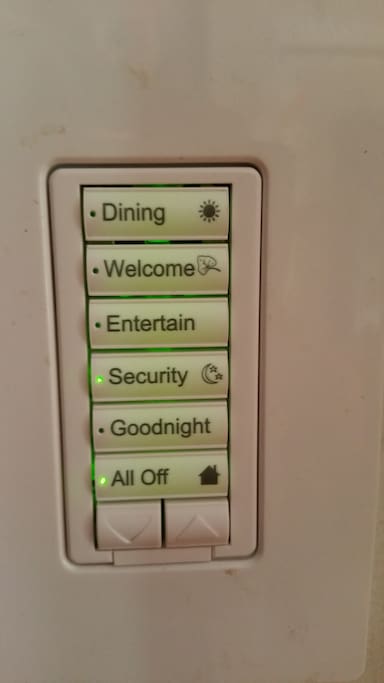 Keypads in this home run scenes so all the lights go to the perfect setting - plus you can raise or lower them all with the up and down arrows.