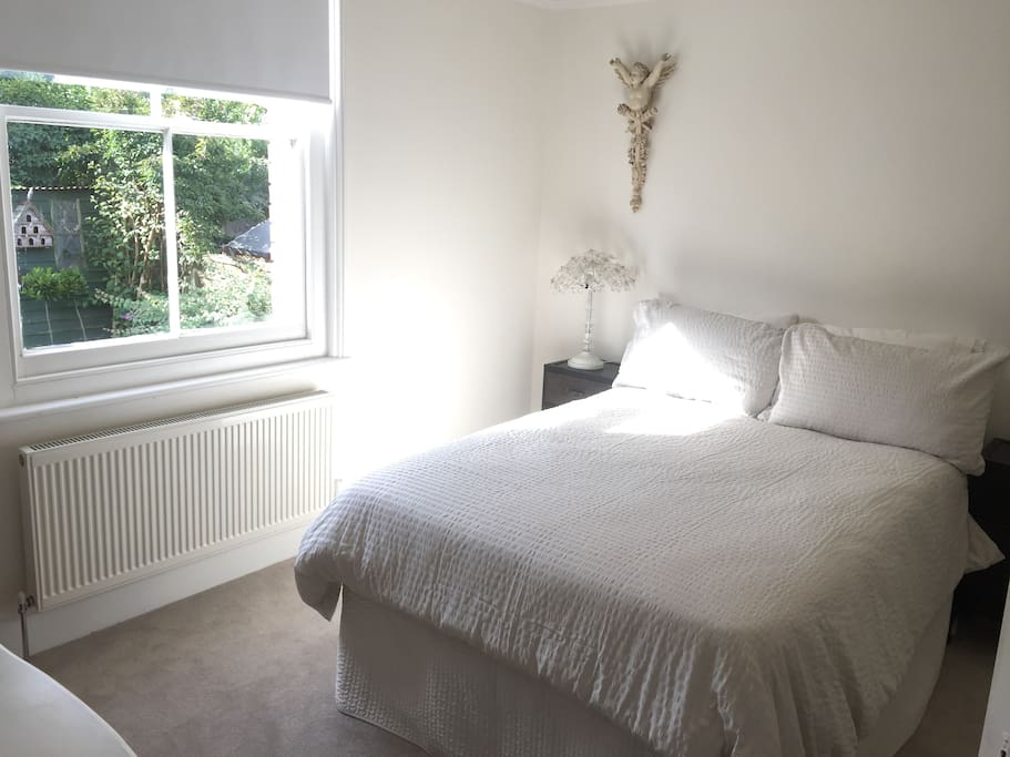 Cosy garden bedroom next to bathroom.