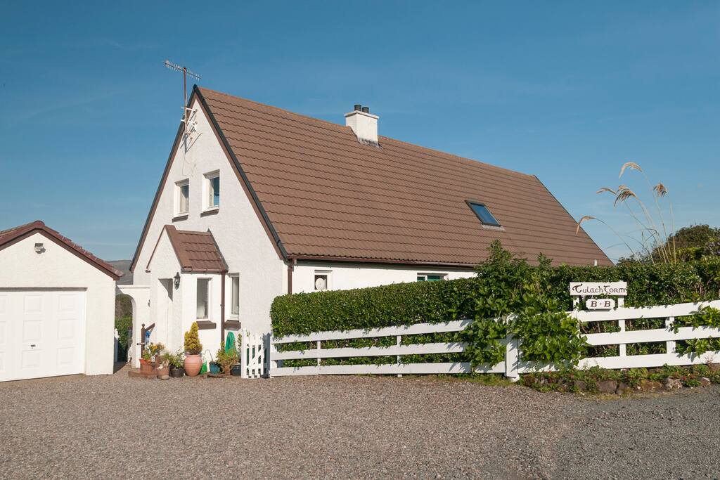 View of the house from the road with space for parking.
