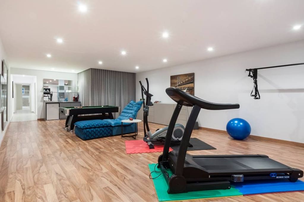 Gym and fitness area with bar and billiard table