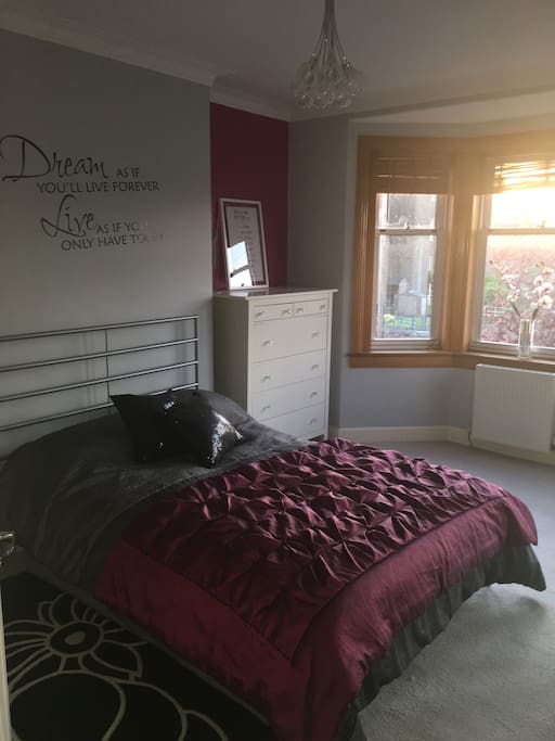 A large bright double bedroom with lots of wardrobe space