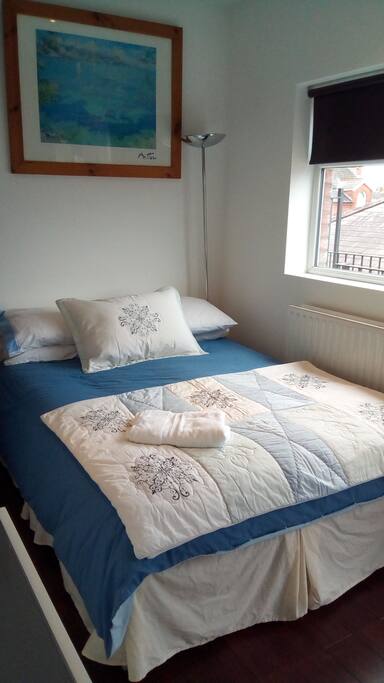 Bedroom 1 which has glass door to balcony and mirrored, sliding door wardrobes