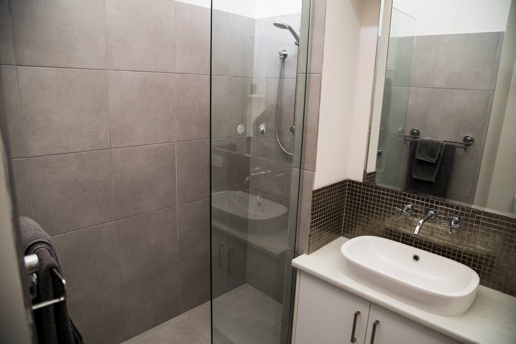 Enjoy a nice hot shower in this modern walk-in style bathroom