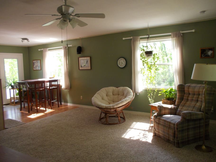 Great room is very spacious and has large windows facing three directions and an in-wall stereo system.