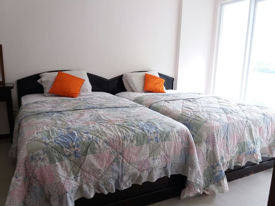 This is our main bedroom, consist of two single bed. You can enjoy the outside view within the room. We also provide this room with private bathroom and also air conditioner.