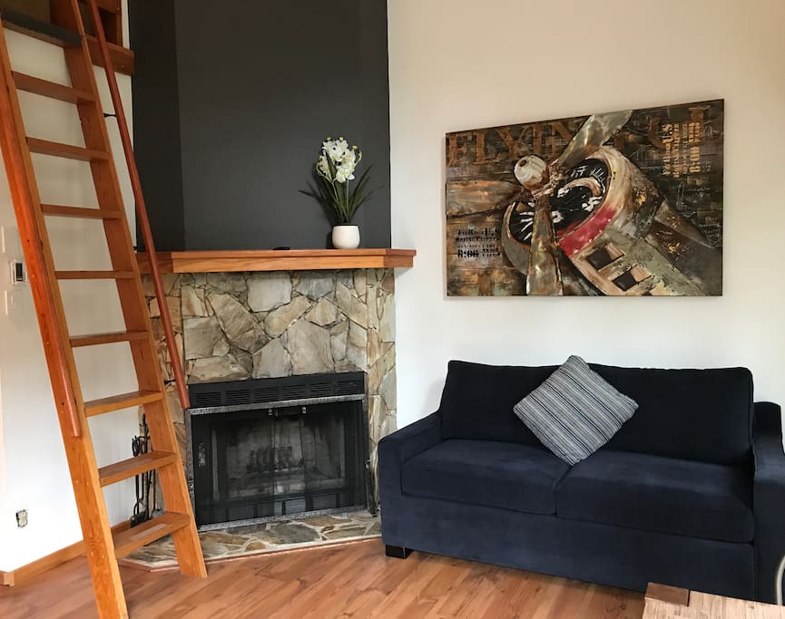Living room with wood burning fireplace.