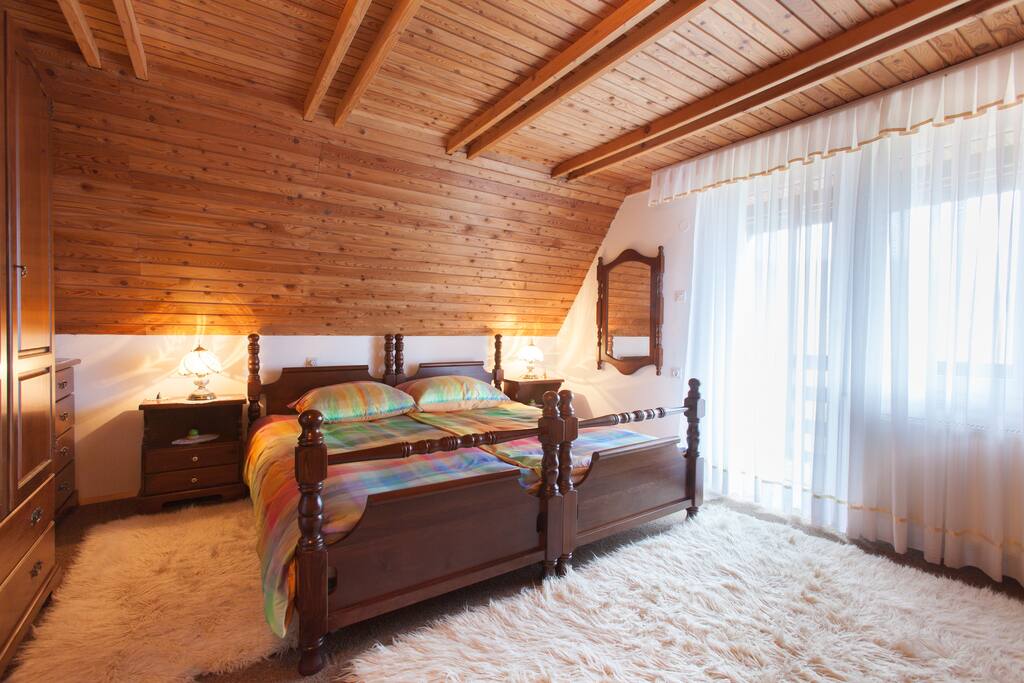Master bedroom for two. Brighter in airy. With exit to balcony with view to Cerknica Lake.