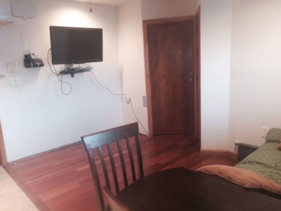 40" TV hardwood floors in open space living room/dining.