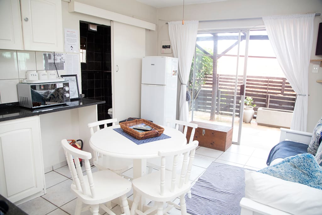 Main living area as seen from bedroom looking towards private patio with barbeque area to the right