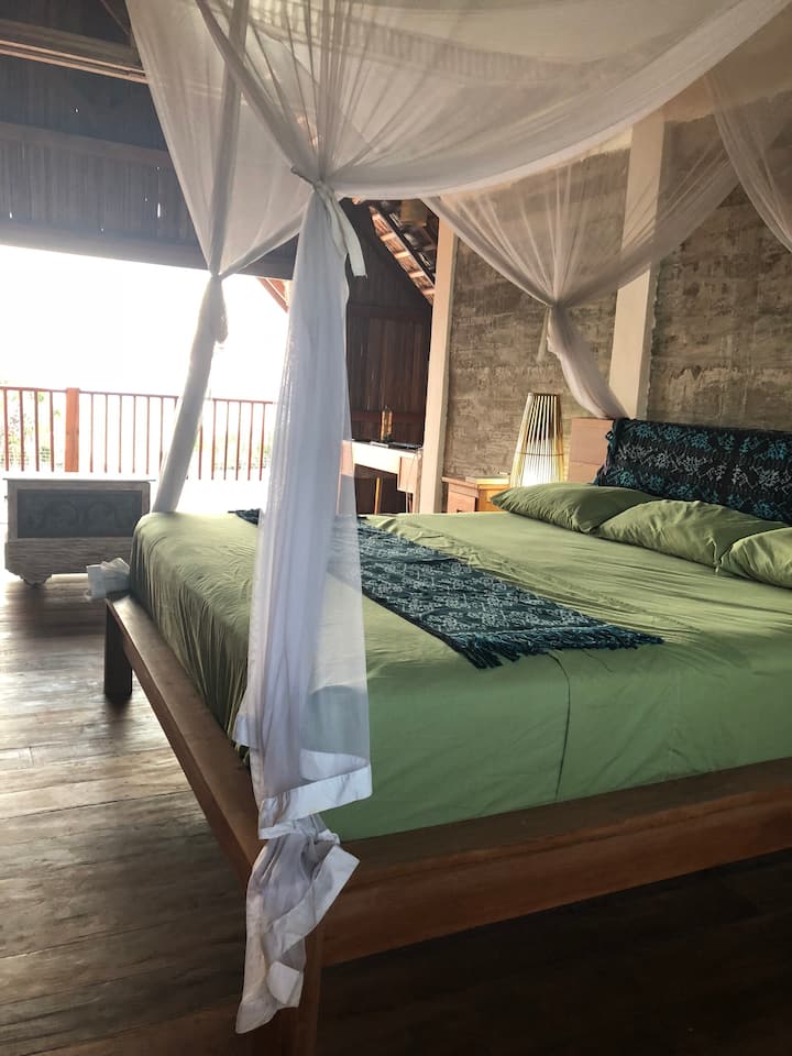 Master bedroom looking to balcony and beach