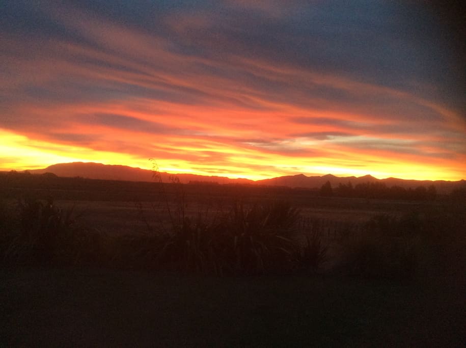 Sun going down front of house