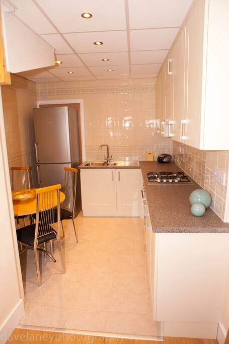Fitted kitchen with table and chairs.