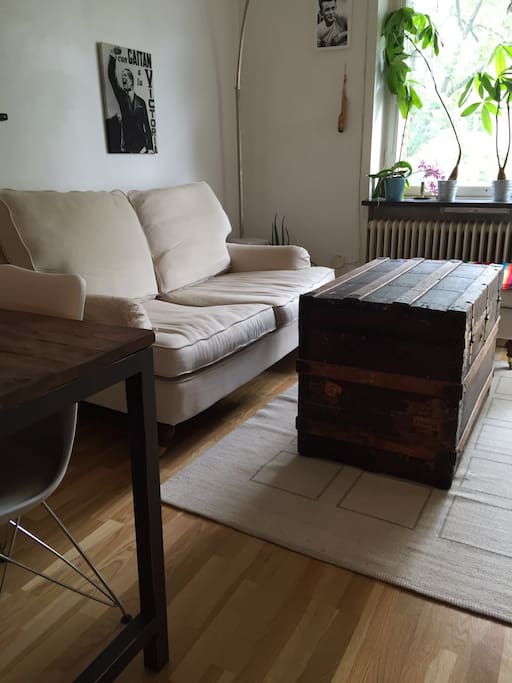 Sofa infront of TV, next to the entrance to the balcony