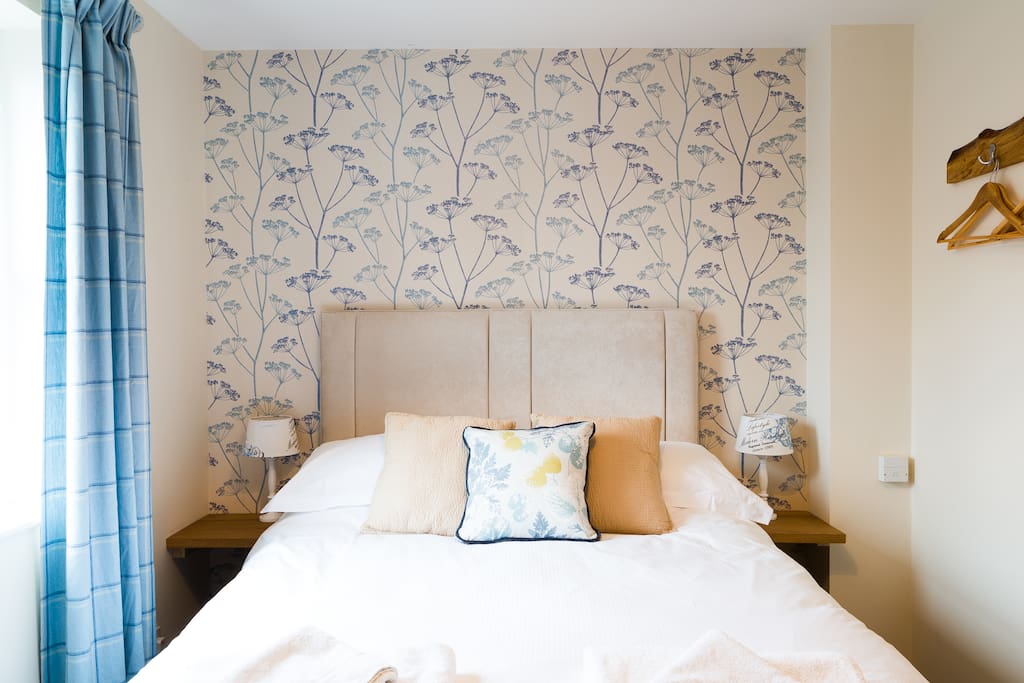 Lovely fresh,crisp bedding and towels are provided for guests. Oak hand made hanging clothes hooks.