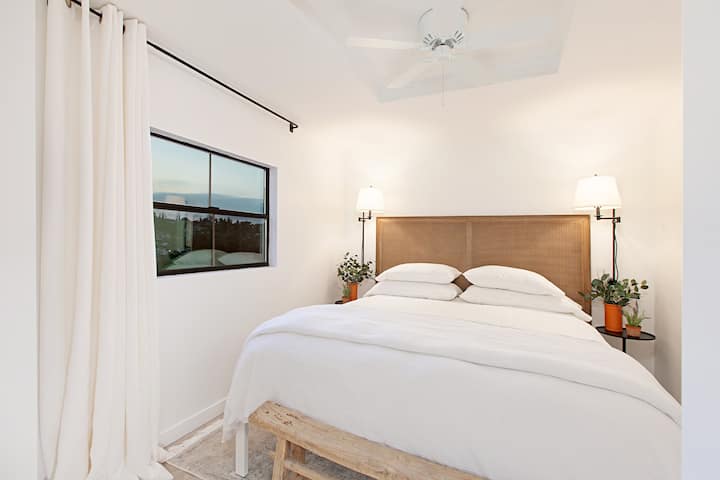 King size bed with luxury linens and pillows.