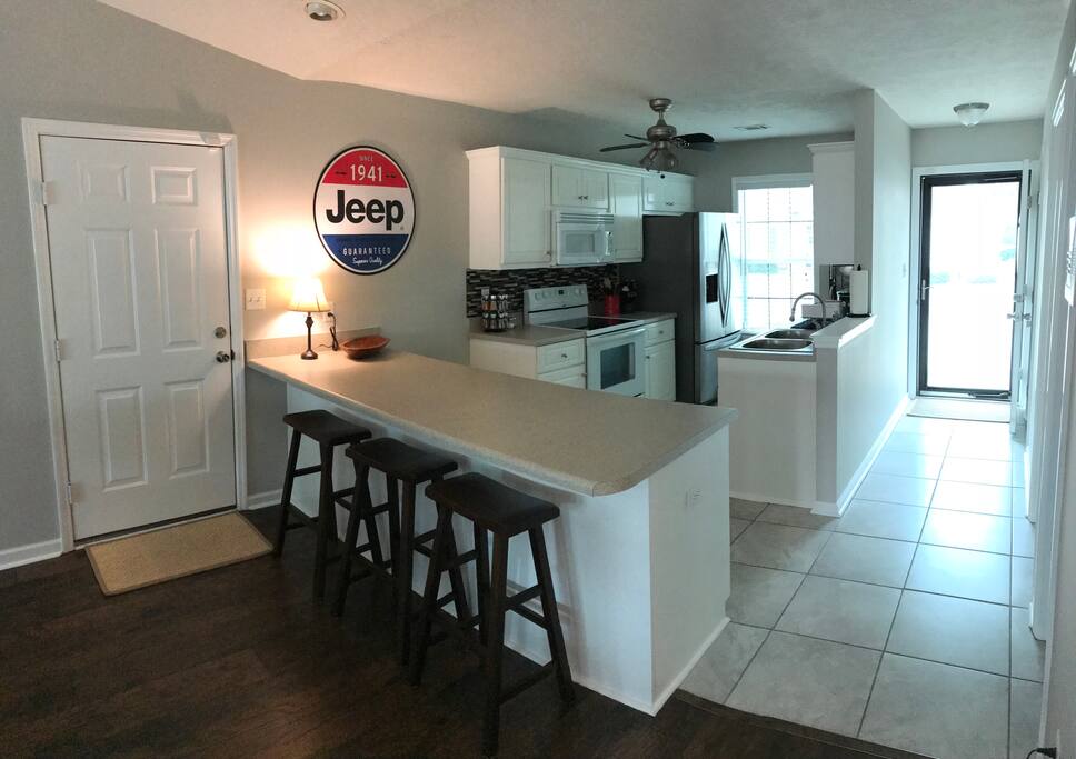Kitchen has everything you need to whip up a quick dinner after a long day in the sun. Screen door offers guest an abundance of natural light.