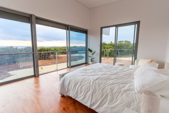 Master bedroom with King size bed, ensuite and sitting area.
Panoramic ocean and native bushland views