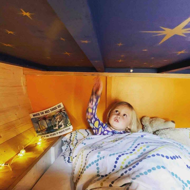 Children’s floor bed with starry sky above 