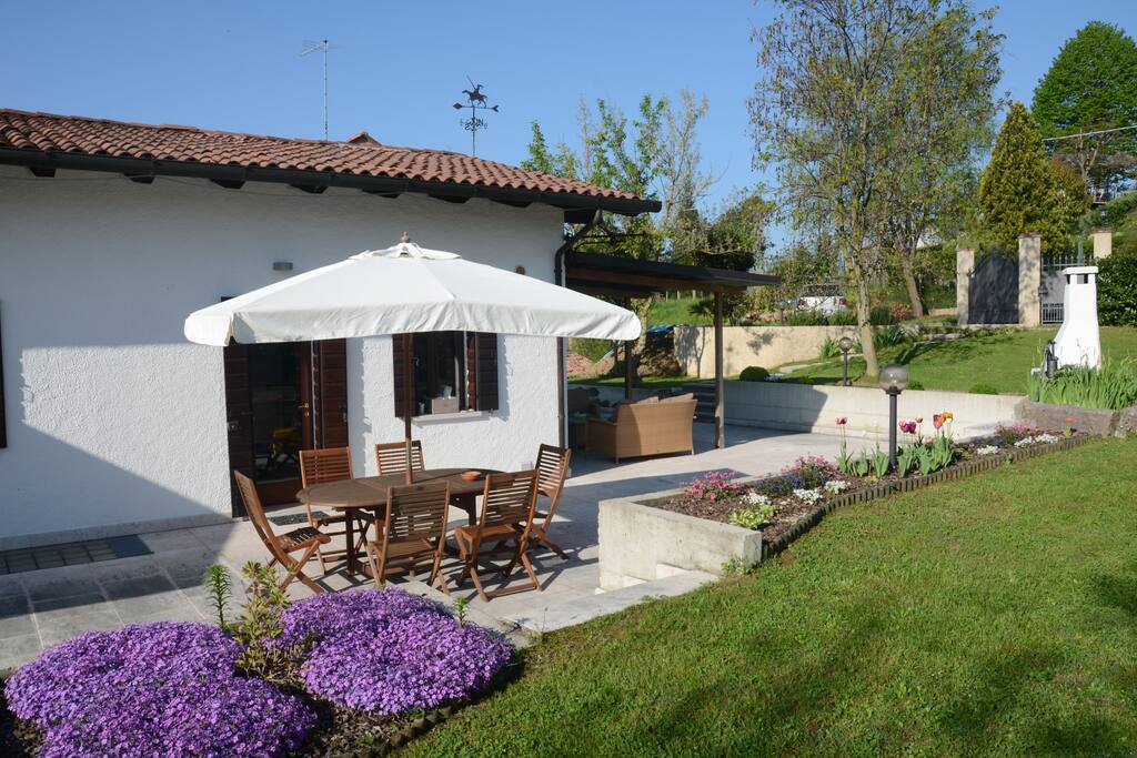 Sunlit terrace with outdoor dining table, with a door right to the kitchen.
