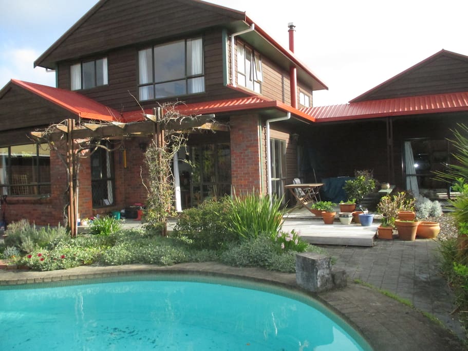 Outside verandah, garden area and pool.