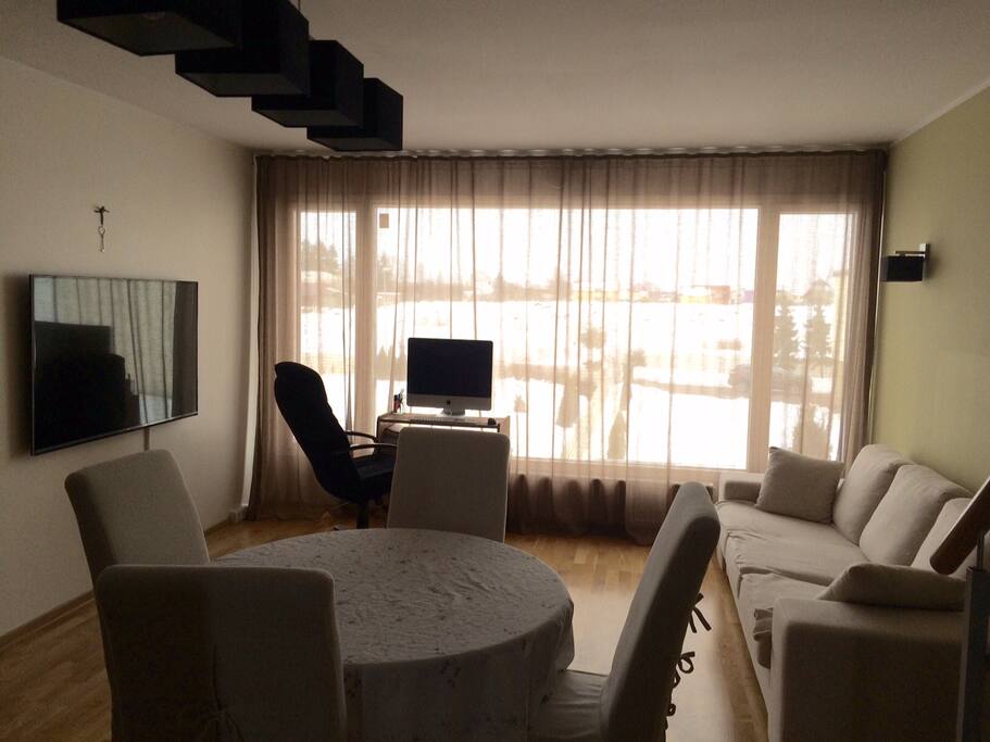 Living room with couch and 60" ULTRA HD TV.