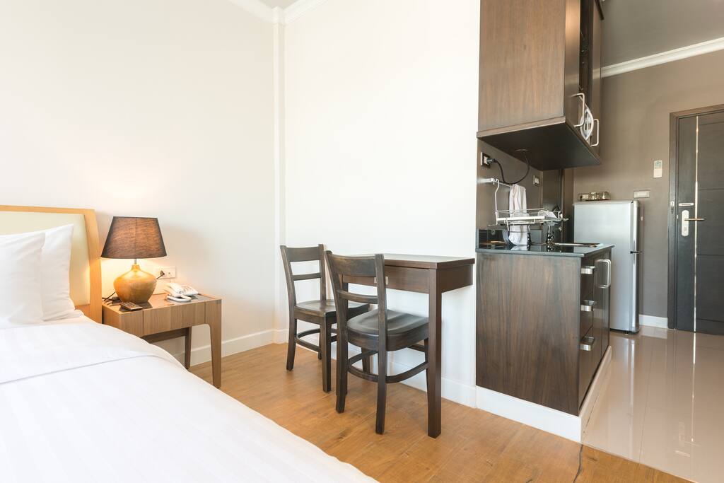 Room 301 - In room working desk, wardrobe and simple kitchen.