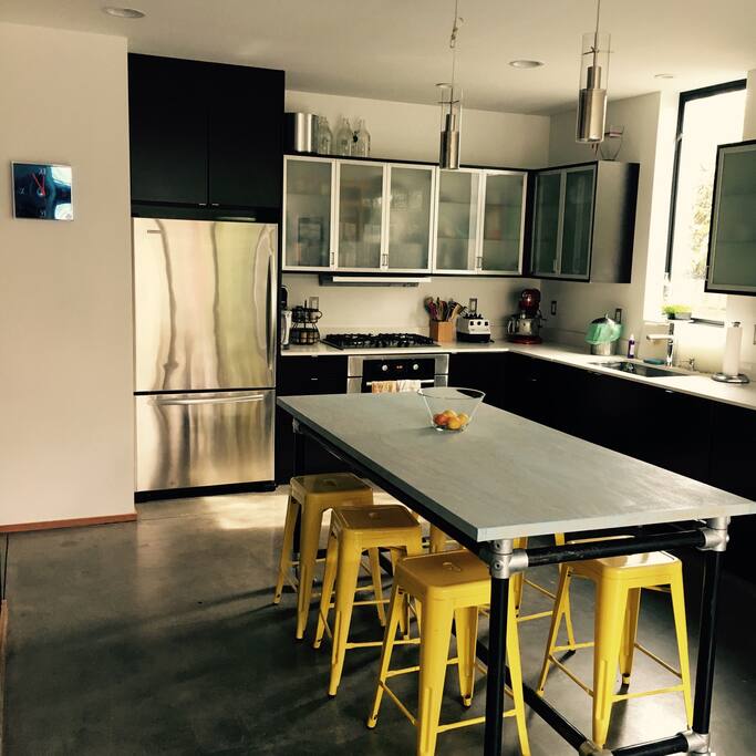 Kitchen with counter height island table.
