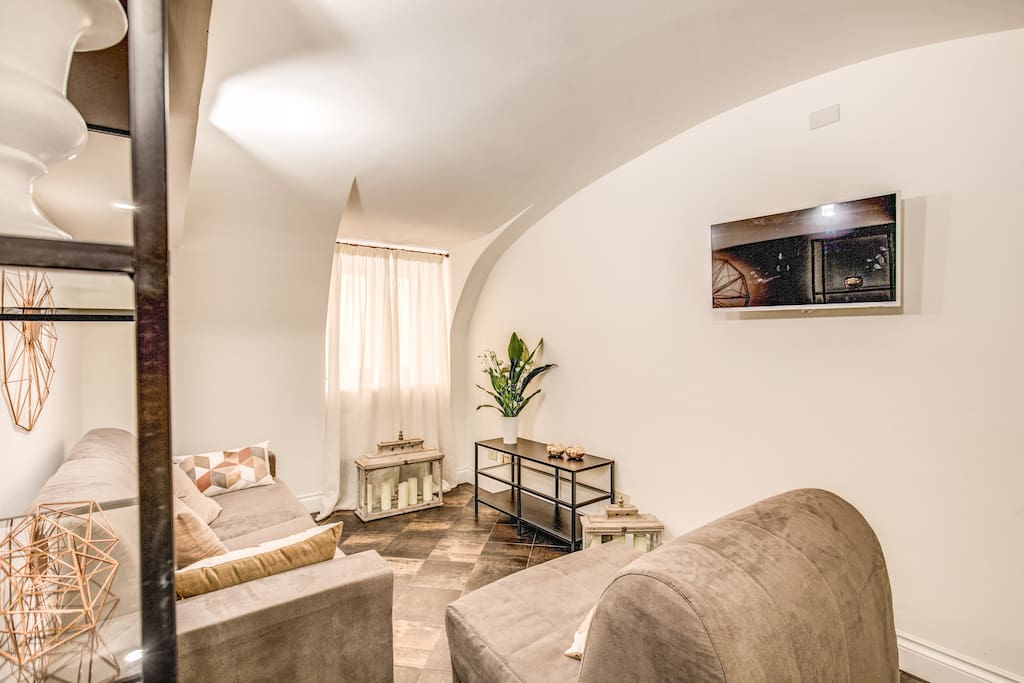 Living room with 2 sofa beds (1 double and 1 single), 1 folding table, TV and air conditioning