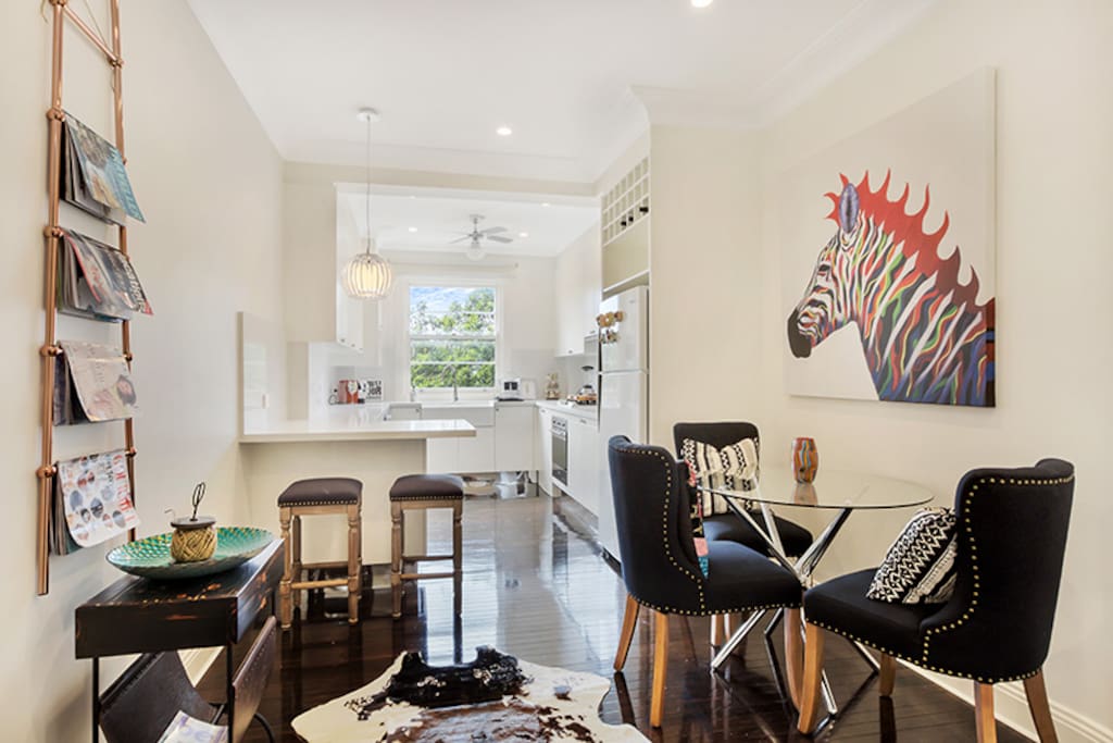 Separate dining room with open plan kitchen, breakfast bar. Two beautiful rosellas will sing to you every morning from the trees outside the kitchen window.