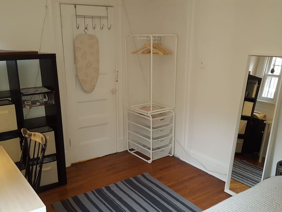 Hangers and storage for clothes. Full length mirror.
