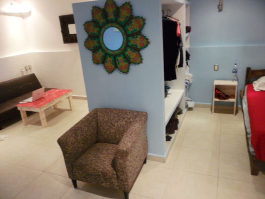 A built-in wardrobe/ entertainment shelving separates the living and bedroom.