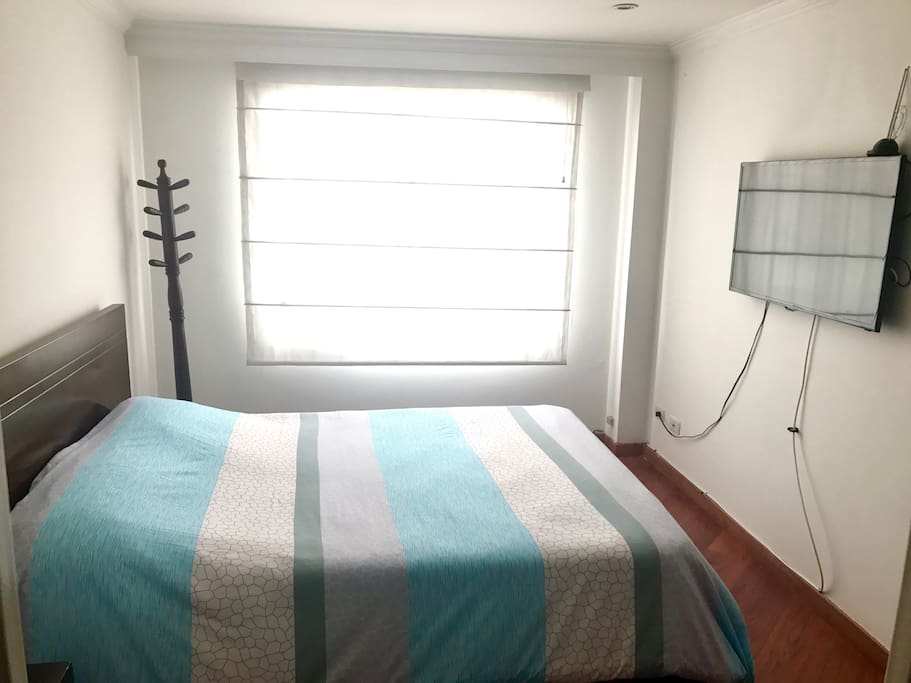 Double size bed, TV, closet and window
