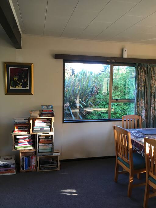 In Fall the tui birds play amongst the red flax outside our dining windows.