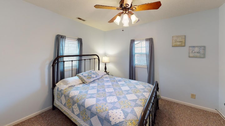 Bedroom 3 features a queen sized bed and a tv with two windows providing great natural lighting!