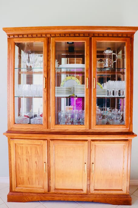 The china cabinet is full of silverware and more. Located in the spacious kitchen.