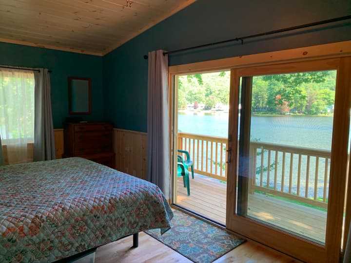 back bedroom with sliders to private deck; seating provided on deck 