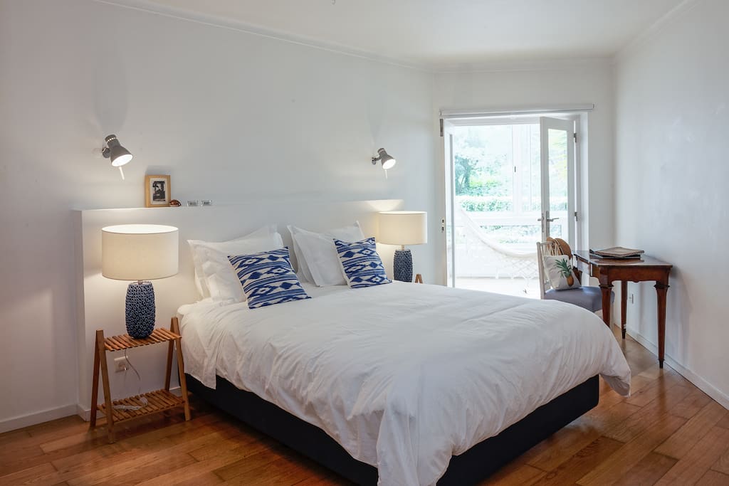 One bedroom with a king-sized bed, a large built-in closet with drawers and a desk/workspace.