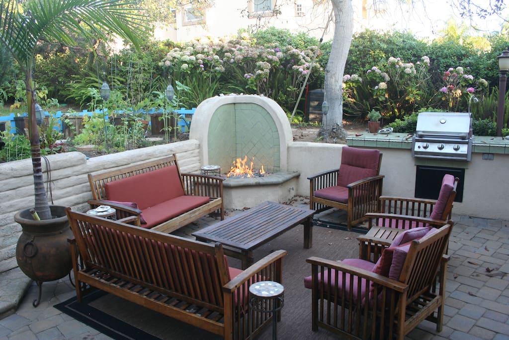 Outdoor BBQ area with garden and grass area above